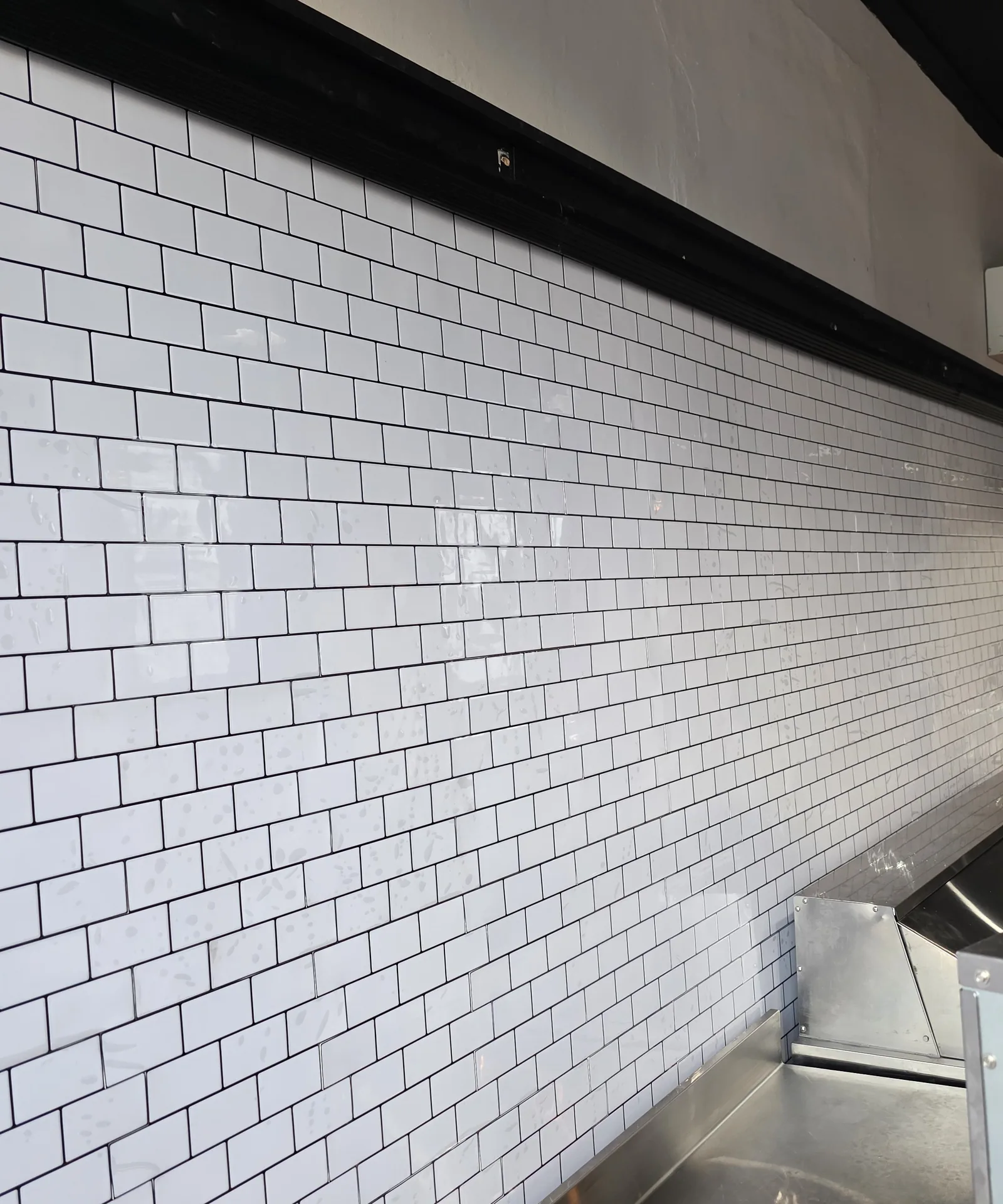 White subway tile along the service wall
